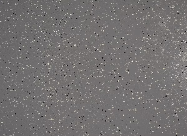 Close-up of an epoxy surface with broadcast flakes